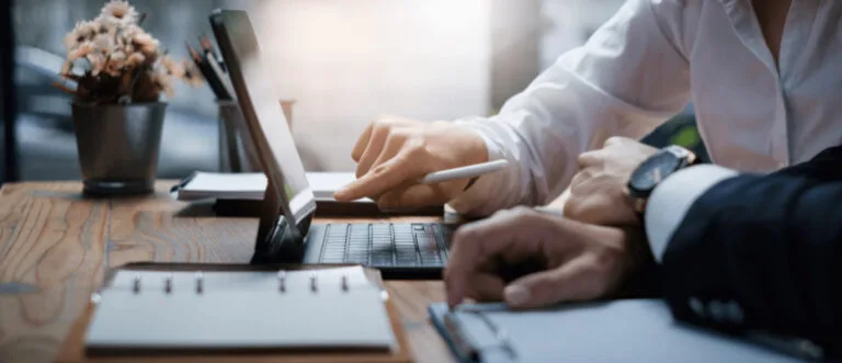 two people looking at a computer