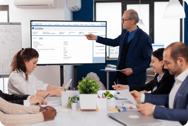 man presenting in front of a team