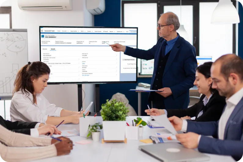 man presenting in front of a team